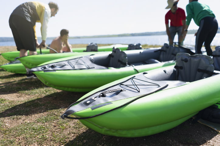 Group of people preparing kayaks