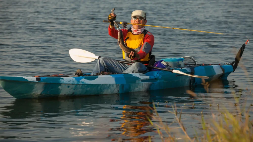 A person holding the fishing the rod while kayak fishing