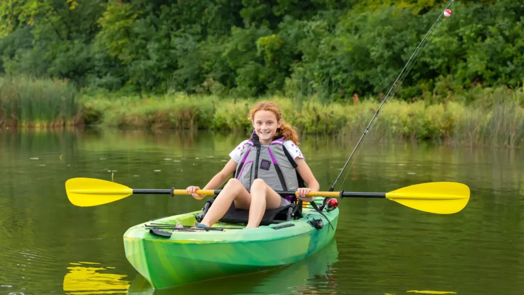 A girl smiling during kayak fishing