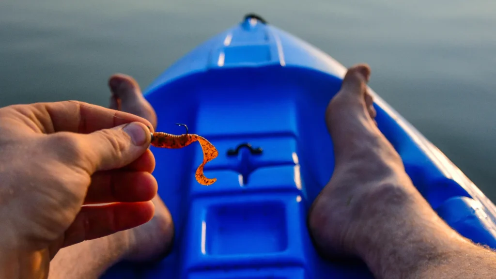 A closeup of a person holding a bait while kayak fishing